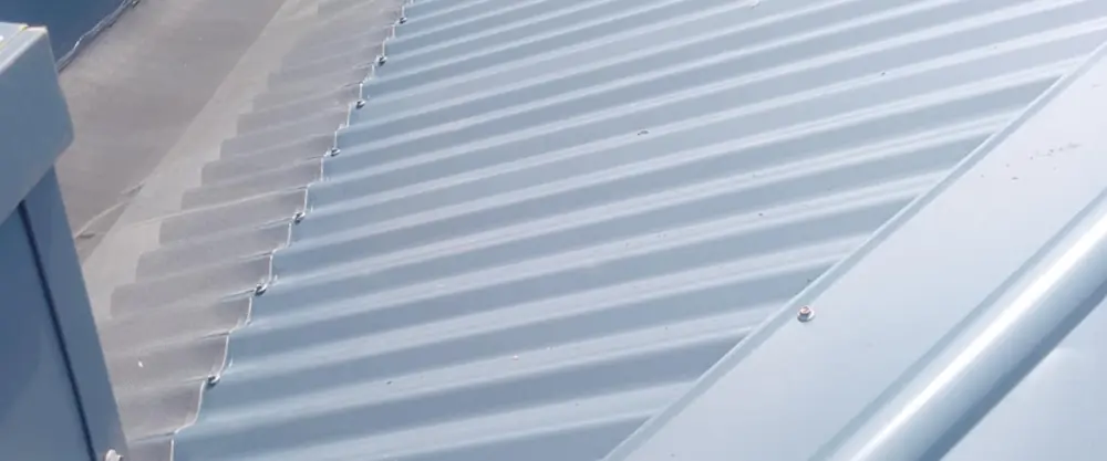Mesh running the length of a box gutter on a commercial roof