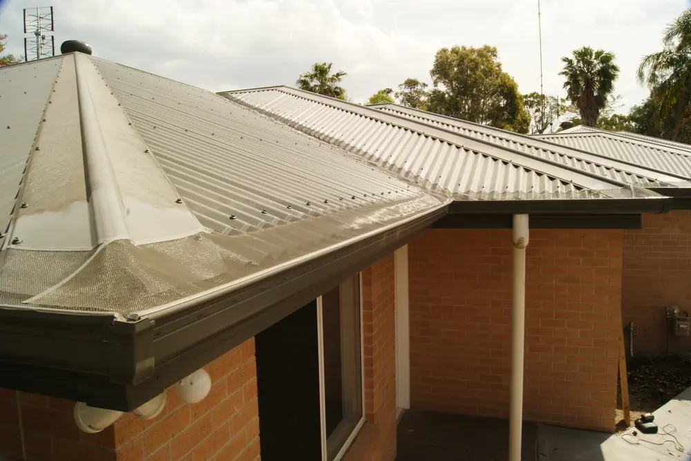 A hip roof with gutter mesh running along the full length of the gutter