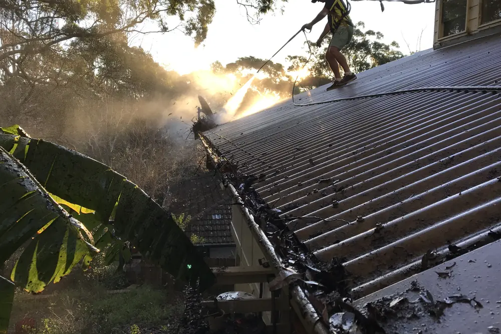 A gutter run being pressure cleaned before gutter mesh is fitted