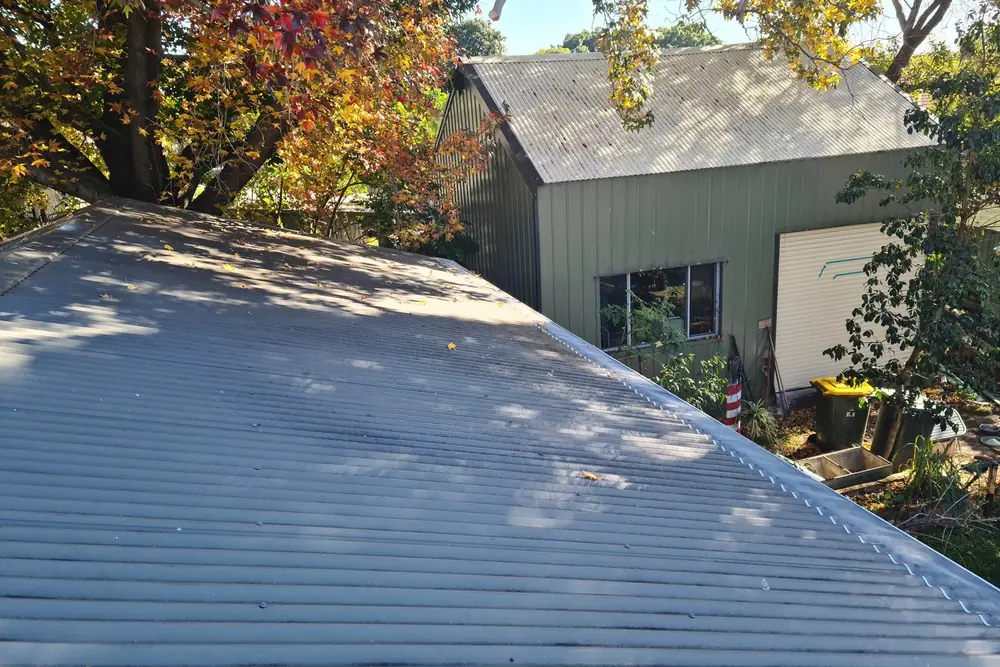 A house roof with gutter mesh running the full length of the gutter