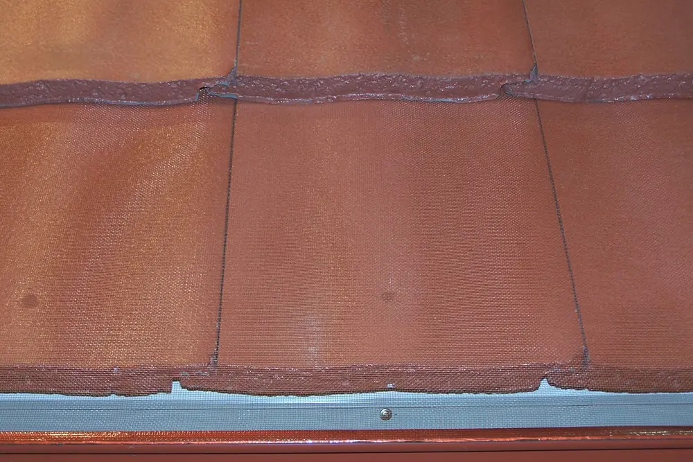 Gutter mesh fitted along the gutter of a terracotta tiled roof
