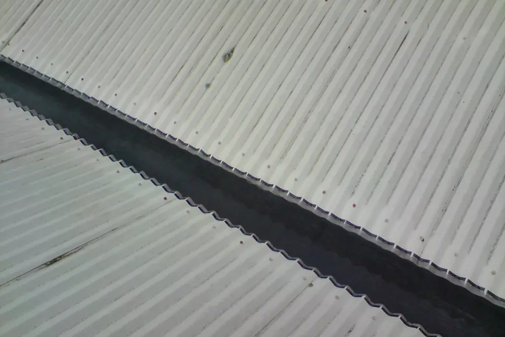 Gutter mesh following the valley line of a metal roof