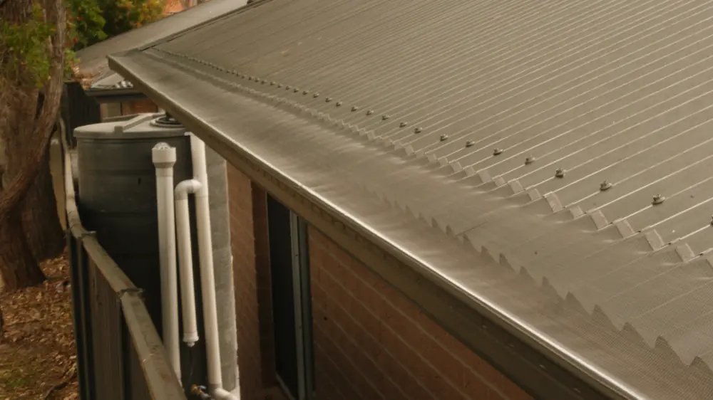 Leaf Free mesh finished cleanly along the gutter line of a residential roof